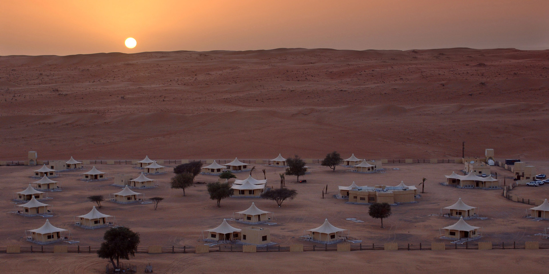 The sun rises on the vast desert which plays host to Desert Nights Camp, Oman